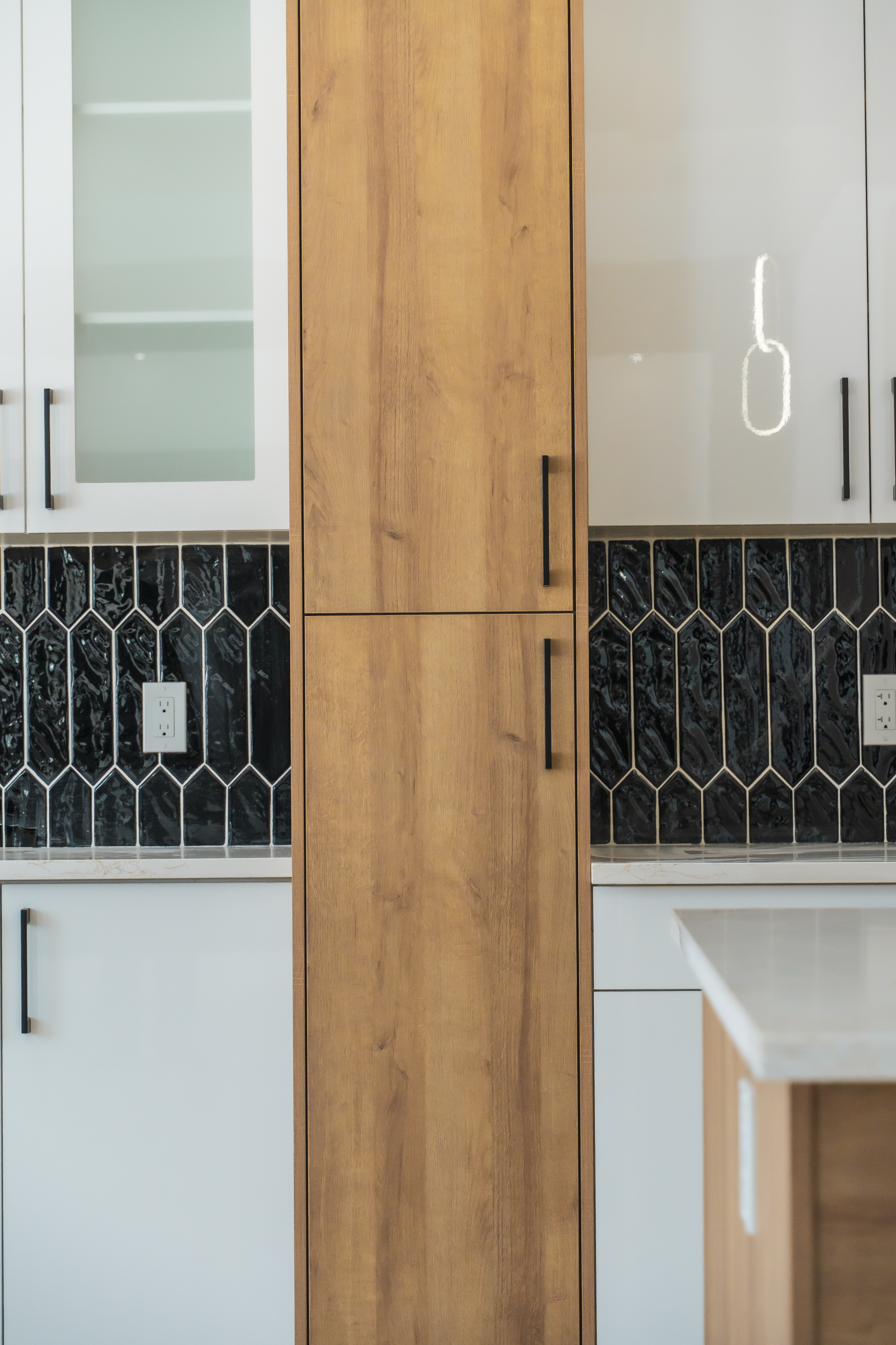 Broad kitchen island and surrounding cabinets – ACE Custom Cabinets