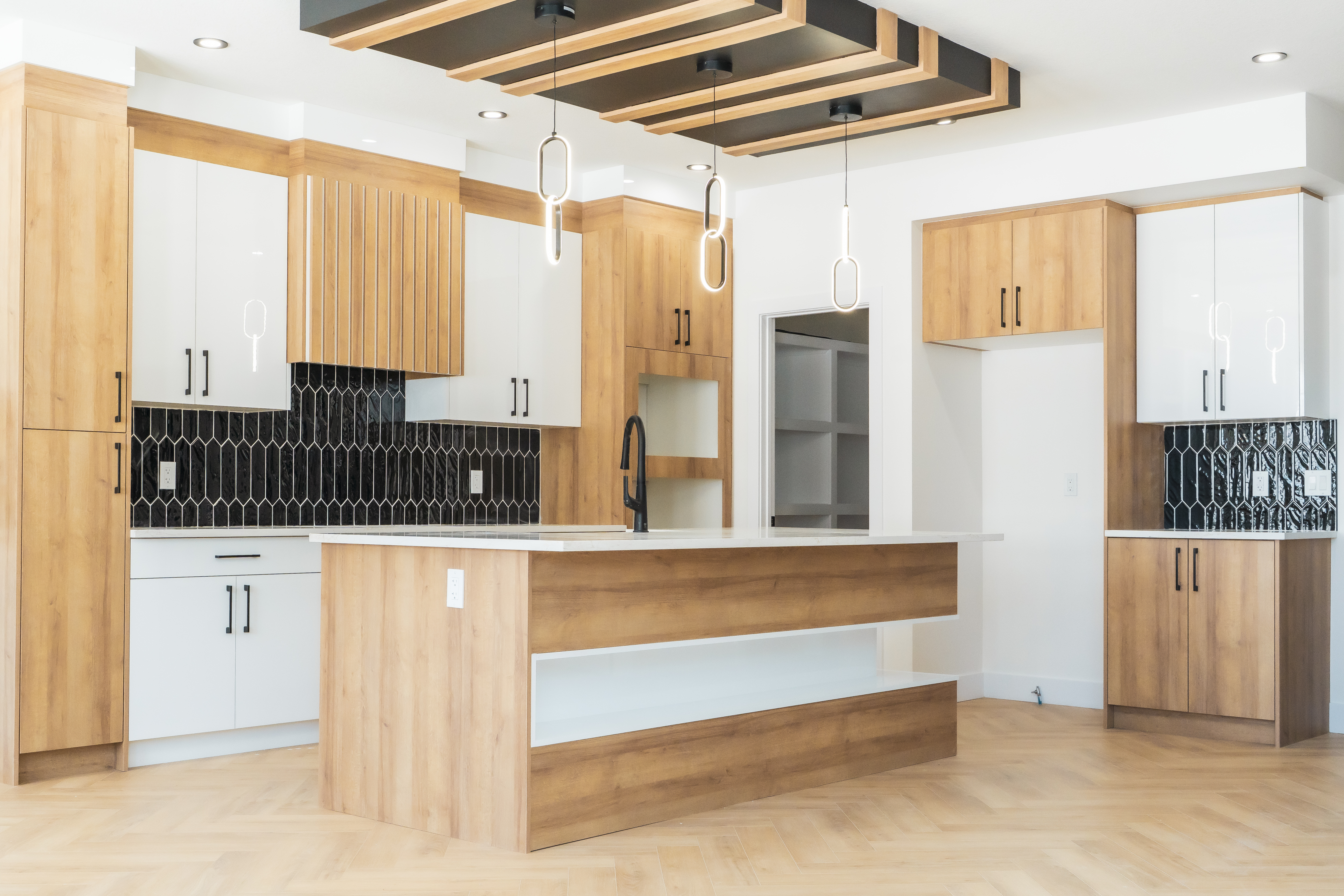 Full kitchen with white and wood cabinetry and herringbone floor – ACE Custom Cabinets