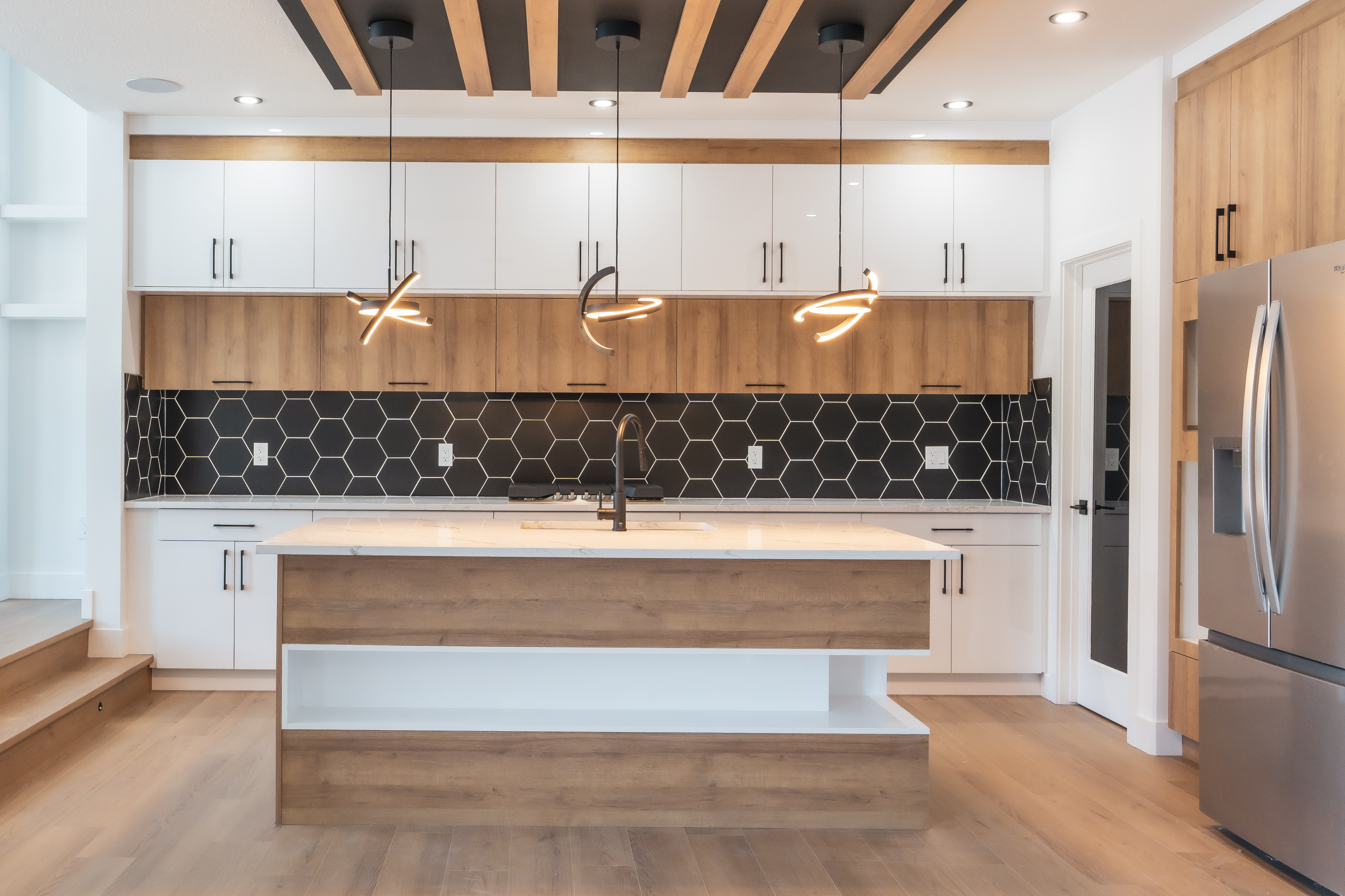 Modern white and wood kitchen with hex backsplash