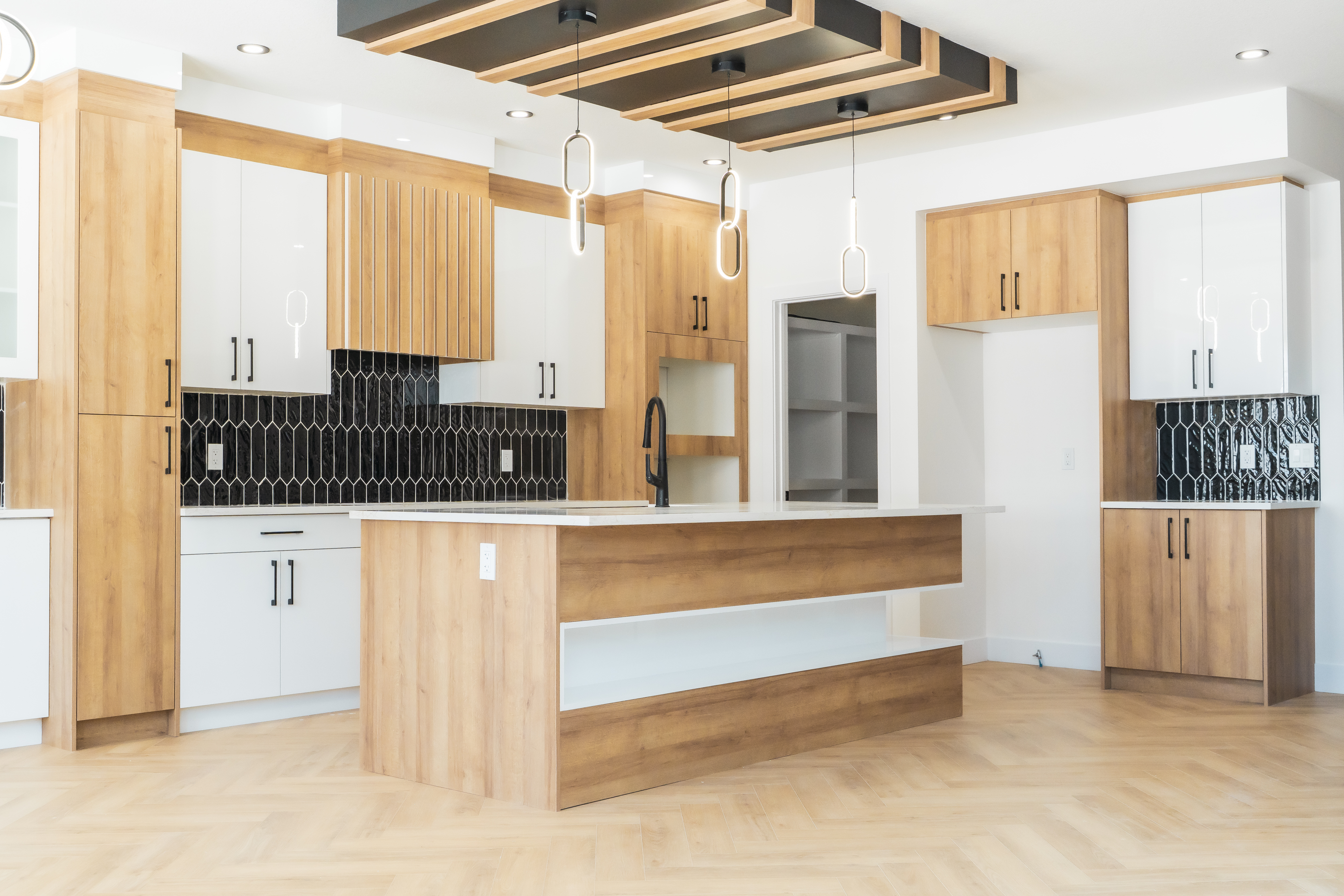 Full kitchen with pendant lighting and cabinetry – ACE Custom Cabinets